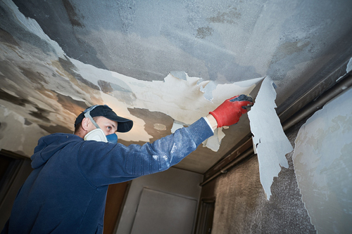 A fire damaged room being repaired.